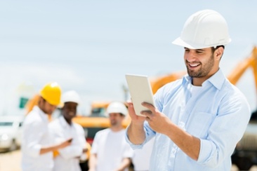 male_engineer_at_a_construction_site_with_a_tablet_computer.jpeg